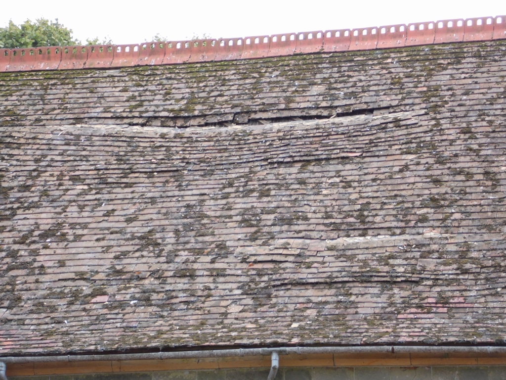 Sagging-roof-and-damaged-tiles